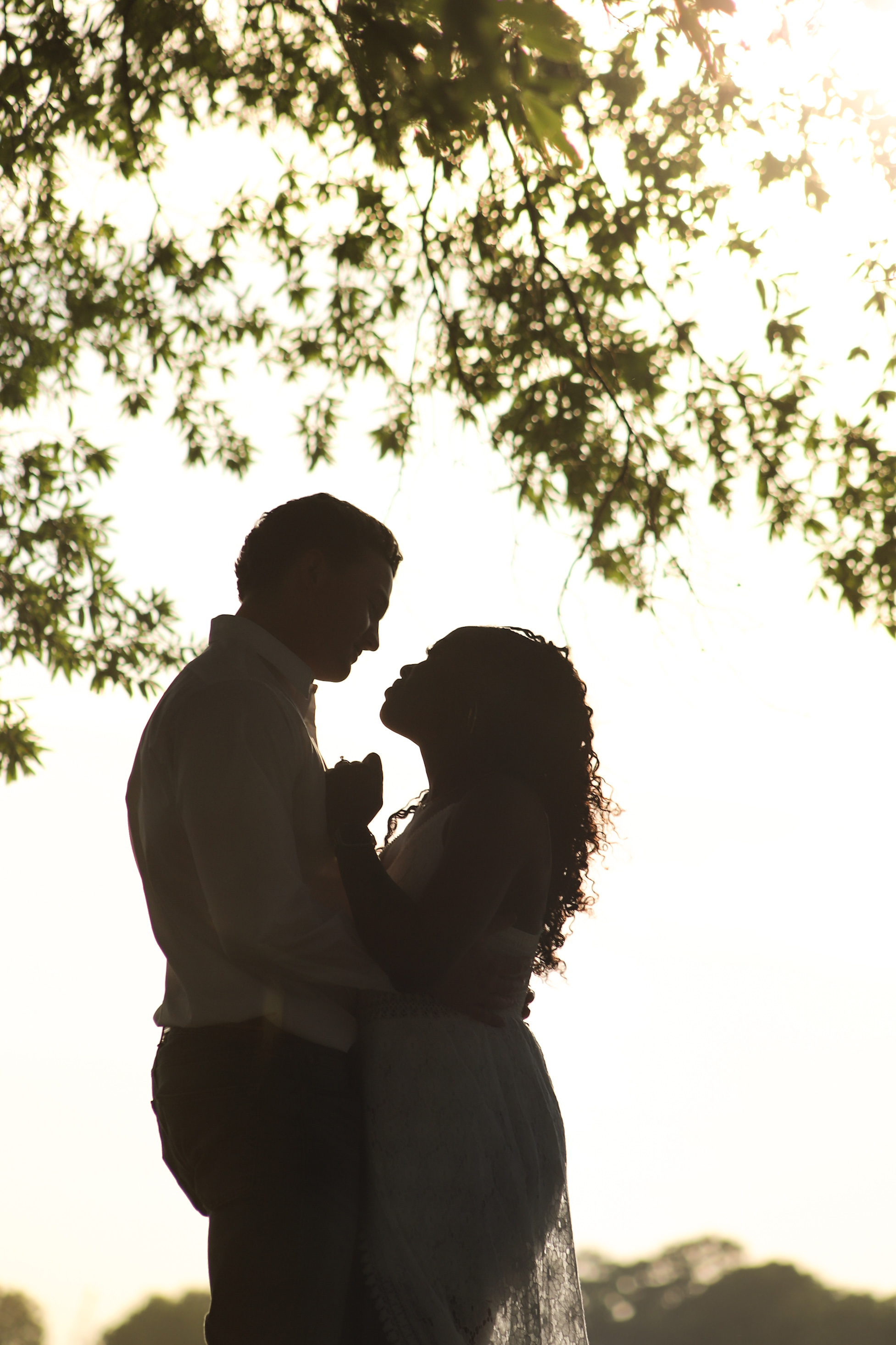 Mark and Guerdithe silhouetted beneath a tree